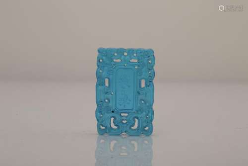 A CARVED BLUE-GLASS PENDANT.QING DYNASTY