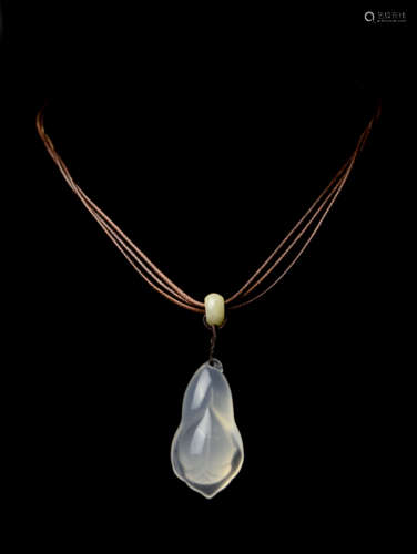 A Finely Carved White Chalcedony Pendant with Magnolia Flower Design