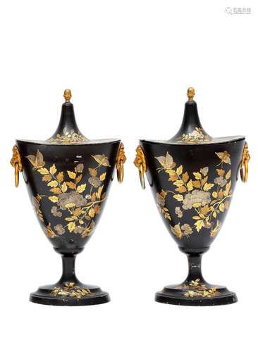 A pair of black and gilt tole peinte chestnut urns, with flower decor