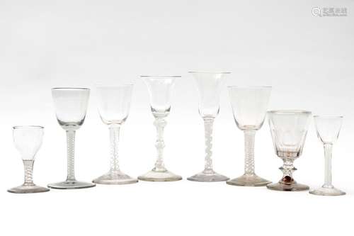 Eight different glasses, mostly with twisted opaque stems