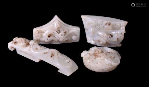 A group of four Chinese white jade sword fittings
