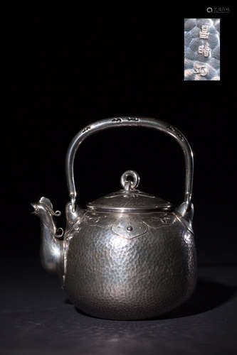 A SILVER TEAPOT WITH PHOENIX LID