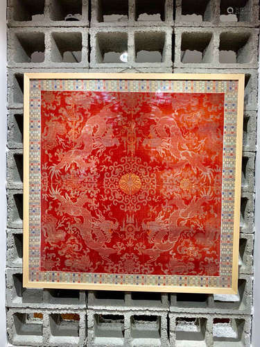 A RED BROCADE SCREEN DEPICTING DRAGON PLAYING WITH BALL