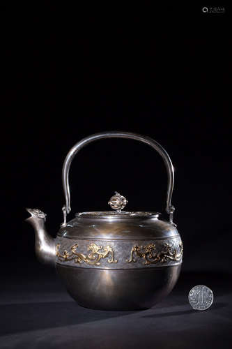 A SILVER TEAPOT WITH GILT SILVER BEAST PATTERNS