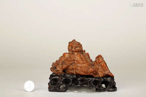 A HUANGYANG WOOD ORNAMENT OF AN OLD MAN