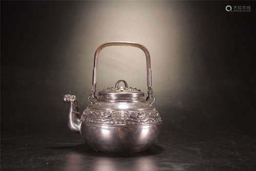 A SILVER TEAPOT WITH PATTERNS AND ZANGLIUJU MARKING