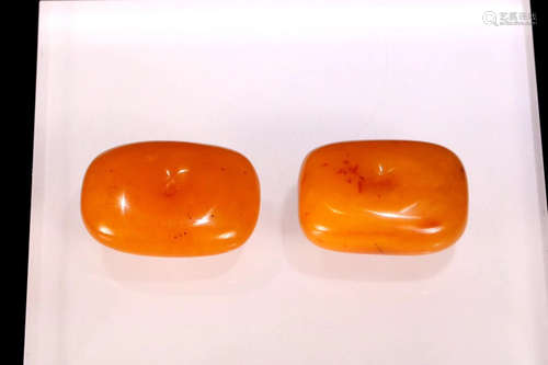 A PAIR OF TIBETAN CRACKER SHAPE  AMBER ORNAMENT