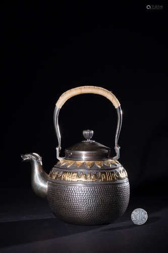 A SILVER TEAPOT WITH GILT SILVER BEAST PATTERNS AND MARKING