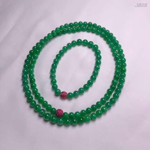 A JADEITE NECKLACE WITH TWO 18K GOLD RED RUBY BEADS