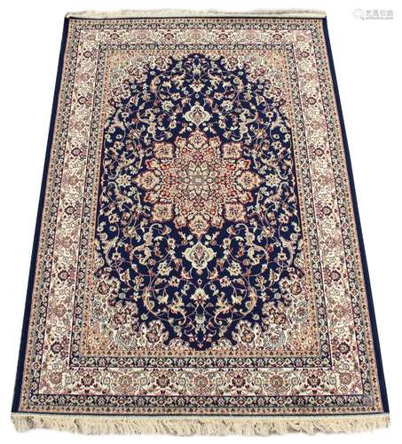 A Kashan style rug with blue ground, 79 by 55ins. (200 by 140cms.) (see illustration).