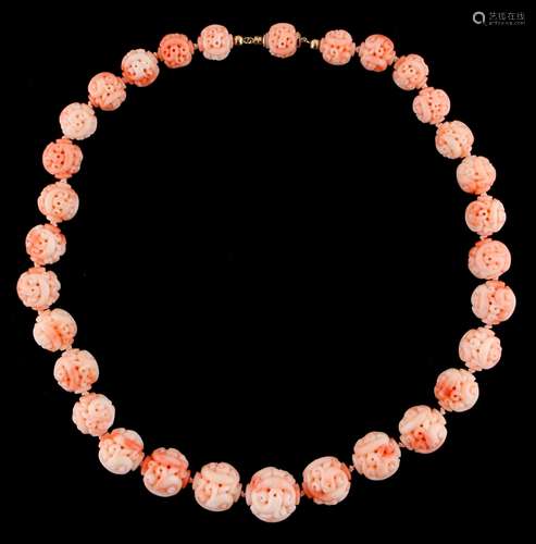 A Chinese carved coral graduated bead necklace, the largest bead approximately 18.5mm diameter,