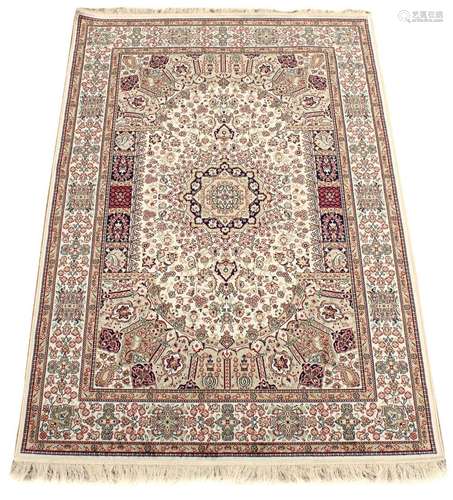 A Kashan style rug with beige ground, 79 by 55ins. (200 by 140cms.) (see illustration).