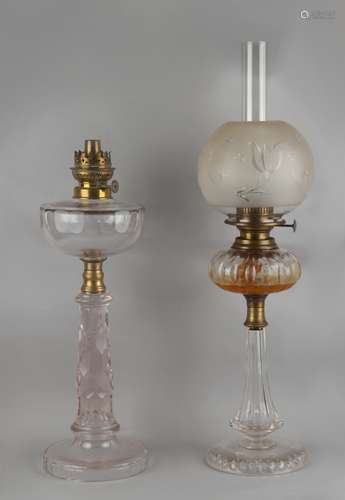 Two early 20th century cut glass paraffin oil lamps, the taller 25.6ins. (65cms.) high (overall) (2)