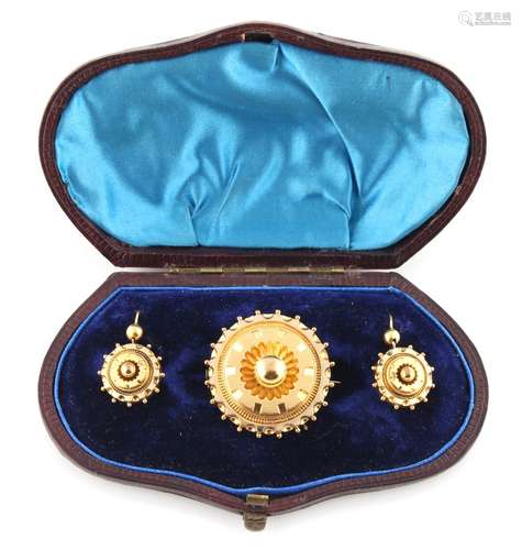 A Victorian unmarked yellow metal circular brooch with earrings en suite, each with diamond