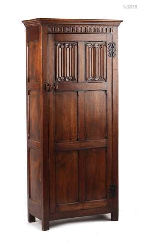 A reproduction carved oak hall cupboard, with linenfold panels, 32.5ins. (82.5cms.) wide (