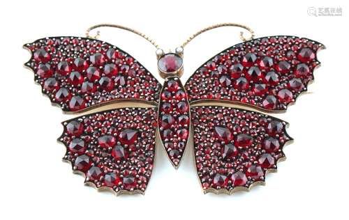 A large garnet butterfly brooch, with rose cut garnets & seed pearl eyes, 78mm across, approximately