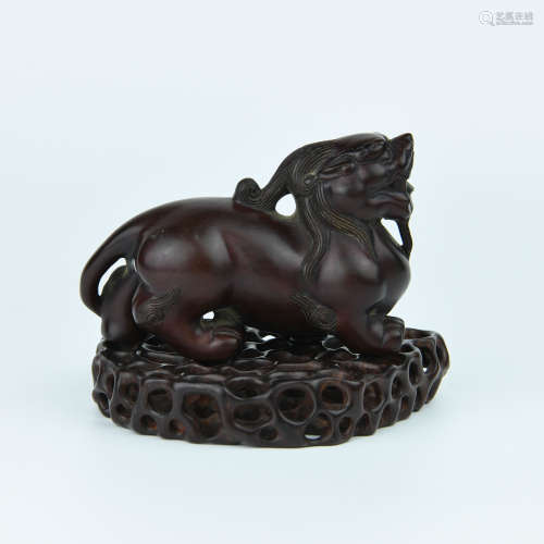 A Chinese Carved Huangyang Foo-Dog with Zitan Stand