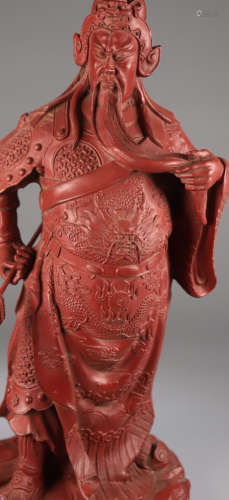 A LACQUER CARVED GUANGONG SHAPED PENDANT