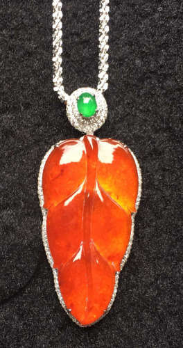 A GREEN JADEITE CARVED LEAF PENDANT, TYPE A