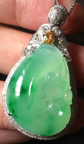 A GREEN JADEITE CARVED PENDANT, TYPE A