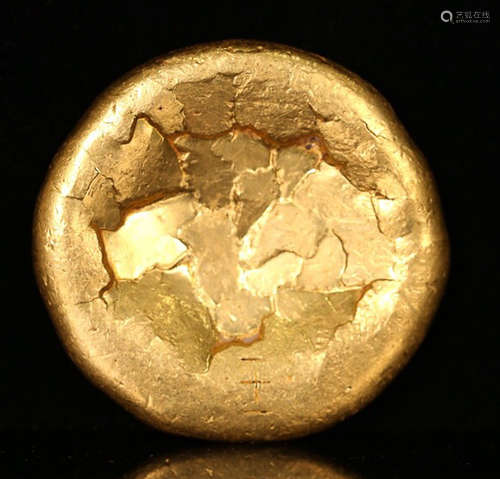 A GOLD ROUND SHAPE INGOT