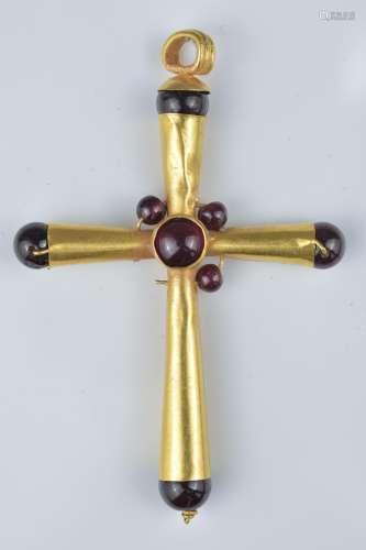 A gold cross pendant with garnet stone (one stone missing). 6cm height