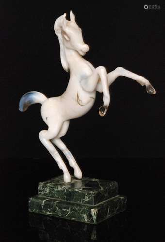 An Istvan Komaromy figural lamp work group of a prancing stallion in tonal white opalescent glass,