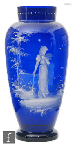 A late 19th Century Continental glass vase of footed ovoid form with collar neck in blue decorated