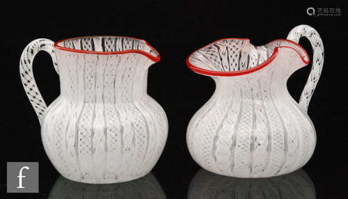 Two French clear glass jugs with internal white latticino decoration to body and handles with red