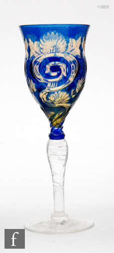 An early 20th Century Stevens & Williams double colour cased wine glass having a slender ogee form