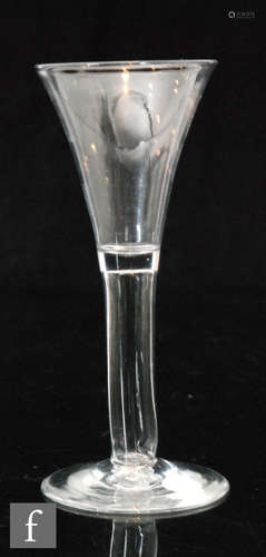 An 18th Century excise glass circa 1750, the drawn trumpet bowl above a hollow blown plain stem,