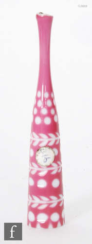 A late 19th Century cheroot holder cased in pink over white and cut with roundels and stylised leaf