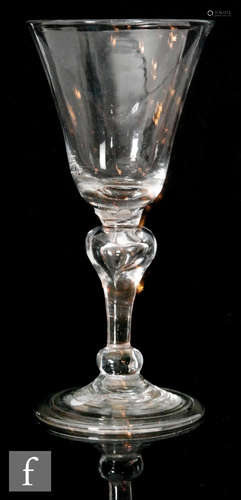 An 18th Century baluster drinking glass circa 1725,