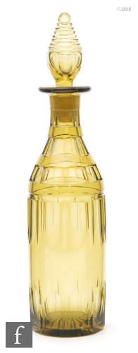 A 19th Century bottle form decanter with slice cut decoration to the deep golden amber ground below