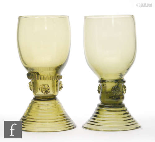 A pair of late 19th Century olive green glass rummers of typical form with ribbed foot and applied