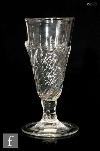 An 18th Century Ale glass with Flamiform bowl of slender round funnel form with a wrythen fluted