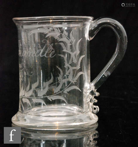 A late Georgian glass tankard, the reed rim, before a slightly tapered cylindrical body,