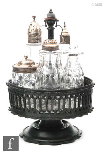 A George III carved ebony condiment stand circa 1800 with a shaped swept foot below a pierced