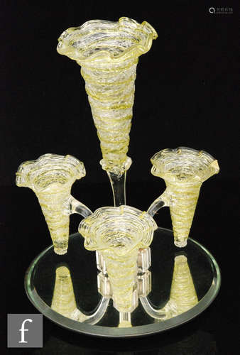 A four flute mirror based epergne each with citron and clear trail work above a clear glass stem,