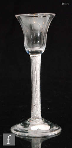 A small 18th Century cordial glass with bell form bowl above a multi series air twist stem,