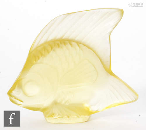 A Lalique glass fish sculpture in a bright yellow, engraved signature, height 4.5cm.