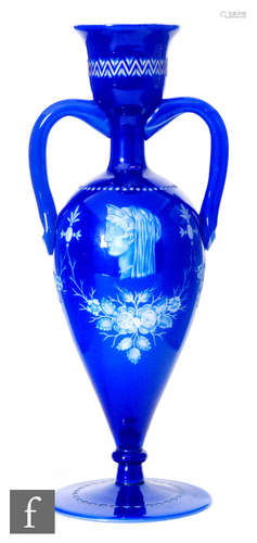 A late 19th to early 20th Century twin handled pedestal vase in blue cased over white and engraved