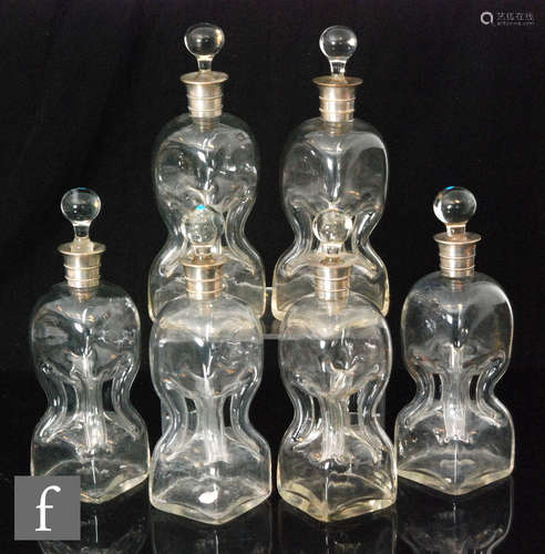 A group of six Edwardian Scrooge decanters, each of plain waisted form,