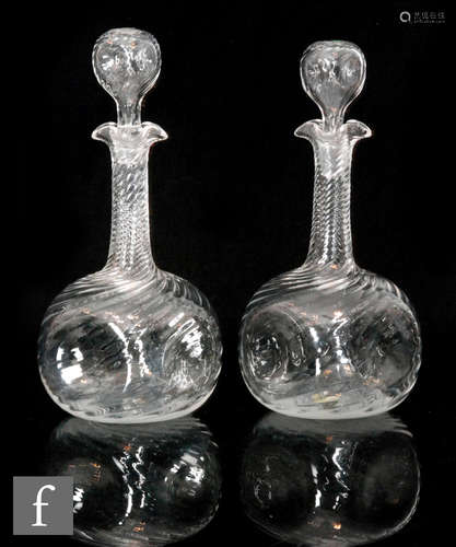 A pair of early 20th Century decanters of dimpled globe and shaft form,