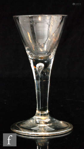 An 18th Century drinking glass circa 1740, drawn trumpet bowl above a plain stem with internal tear,