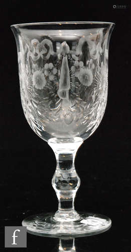 A 1920s to 1930s clear crystal class goblet with a round funnel bowl with flared rim engraved by