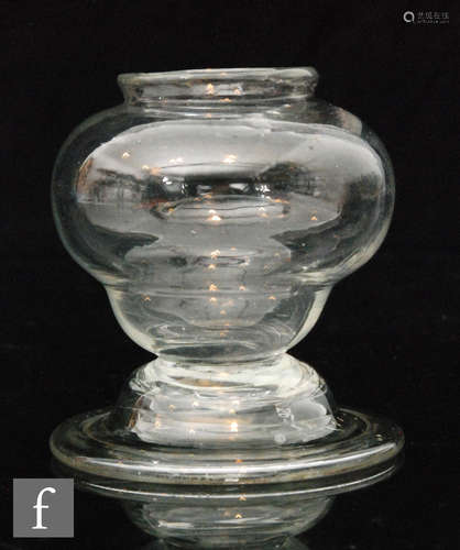 A small 18th Century leach jar circa 1800, lipped ogee bowl above a splayed and folded foot,