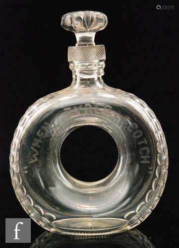 An early 20th Century Stevens & Williams clear cut crystal decanter of donut form cut in the form