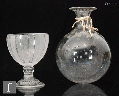 A 19th Century wine flask of spherical form with collar neck engraved with a vine collar and repeat