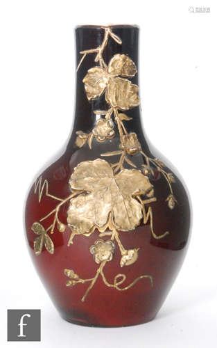 A late 19th Century Harrach glass vase of swollen baluster form with collar neck in maroon cased